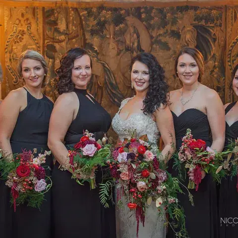 Wendy Day et al. that are standing in front of a flower